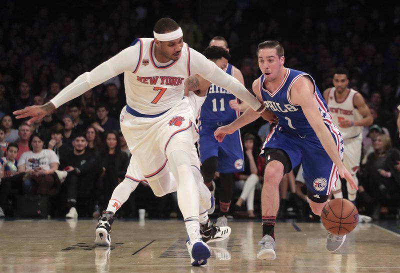 New York Knicks forward Carmelo Anthony (7) looks to strip the ball from Philadelphia 76ers guard TJ McConnell (1) during the first quarter of an NBA basketball game, Saturday, Feb. 25, 2017, in New York. (AP Photo/Julie Jacobson)