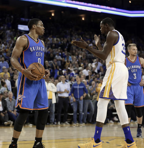 In this Nov. 3, 2016, file photo, Golden State Warriors' Kevin Durant, right, celebrates in front of Oklahoma City Thunder guard Russell Westbrook (0) during the first half of an NBA basketball game, in Oakland, Calif. The next time Russell Westbrook walks into a locker room for a game, Kevin Durant will be there. Get ready for the perhaps the best subplot of All-Star Weekend. The former Oklahoma City teammates and now rivals play as Western Conference teammates Sunday night, Feb. 19, 2017. AP FILE PHOTO