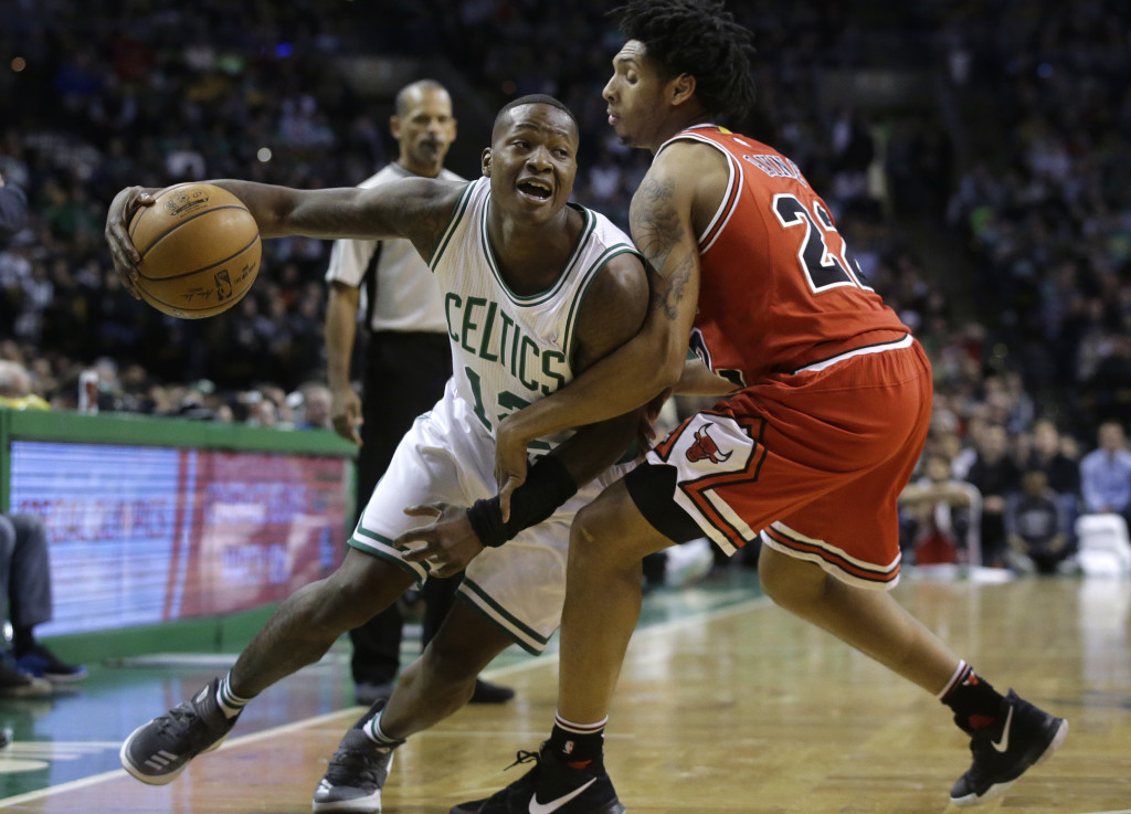 Boston Celtics guard Terry Rozier (12) tries to drive past Chicago Bulls guard Cameron Payne (22) in the fourth quarter of an NBA basketball game, Sunday, March 12, 2017, in Boston. (AP Photo/Steven Senne)