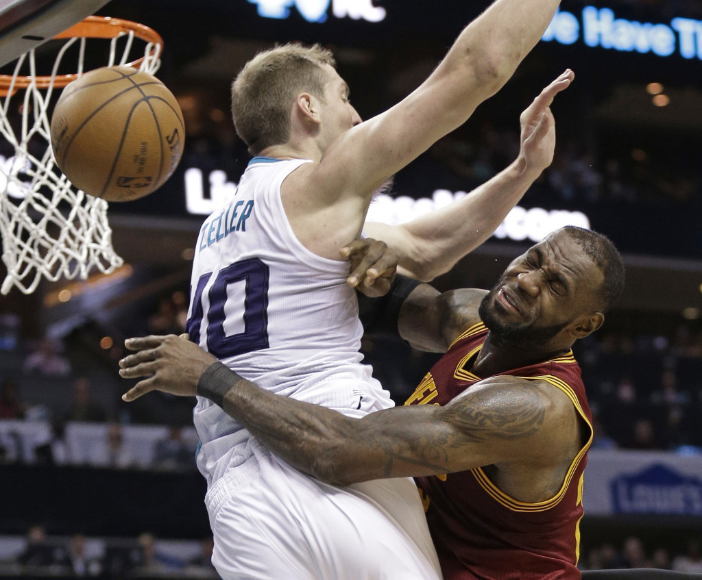 Cleveland Cavaliers' LeBron James, right, is fouled as he drives against Charlotte Hornets' Cody Zeller, left, during the second half of an NBA basketball game in Charlotte, N.C., Friday, March 24, 2017. The Cavaliers won 112-105. (AP Photo/Chuck Burton)