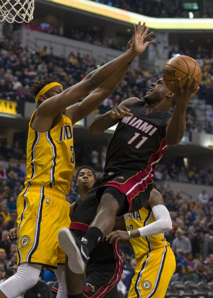 Miami Heat guard Dion Waiters (11) works to get his shot off as he's defended by Indiana Pacers center Myles Turner (33) during the first half of an NBA basketball game, Sunday, March 12, 2017, in Indianapolis. (AP Photo/Doug McSchooler)