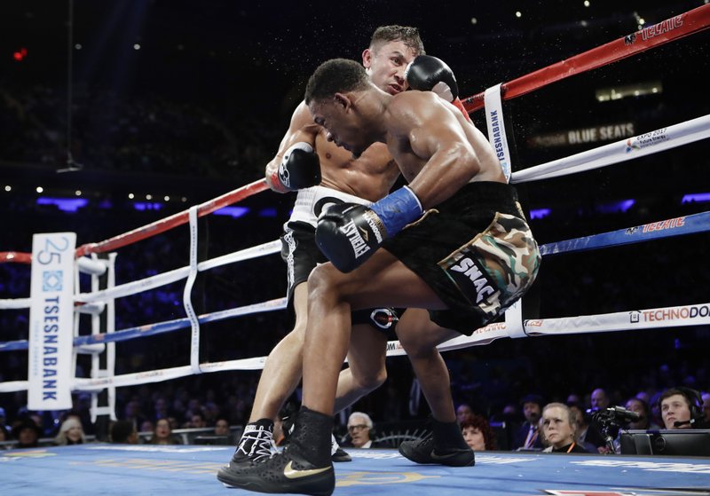 Gennady Golovkin, left, of Kazakhstan, knocks down Daniel Jacobs during the fourth round of a middleweight boxing match early Sunday, March 19, 2017, in New York. (AP Photo/Frank Franklin II)