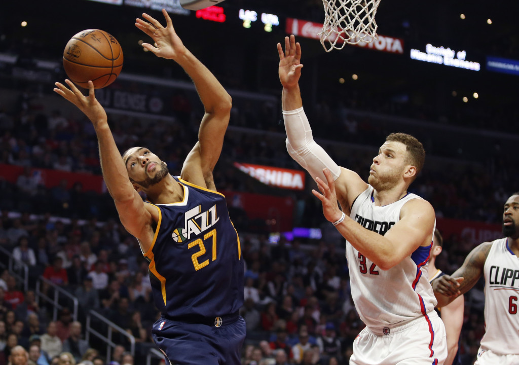 Utah Jazz center Rudy Gobert, left, reaches for a rebound in front of Los Angeles Clippers forward Blake Griffin, right, during the first half of an NBA basketball game, Saturday, March 25, 2017, in Los Angeles. (AP Photo/Danny Moloshok)