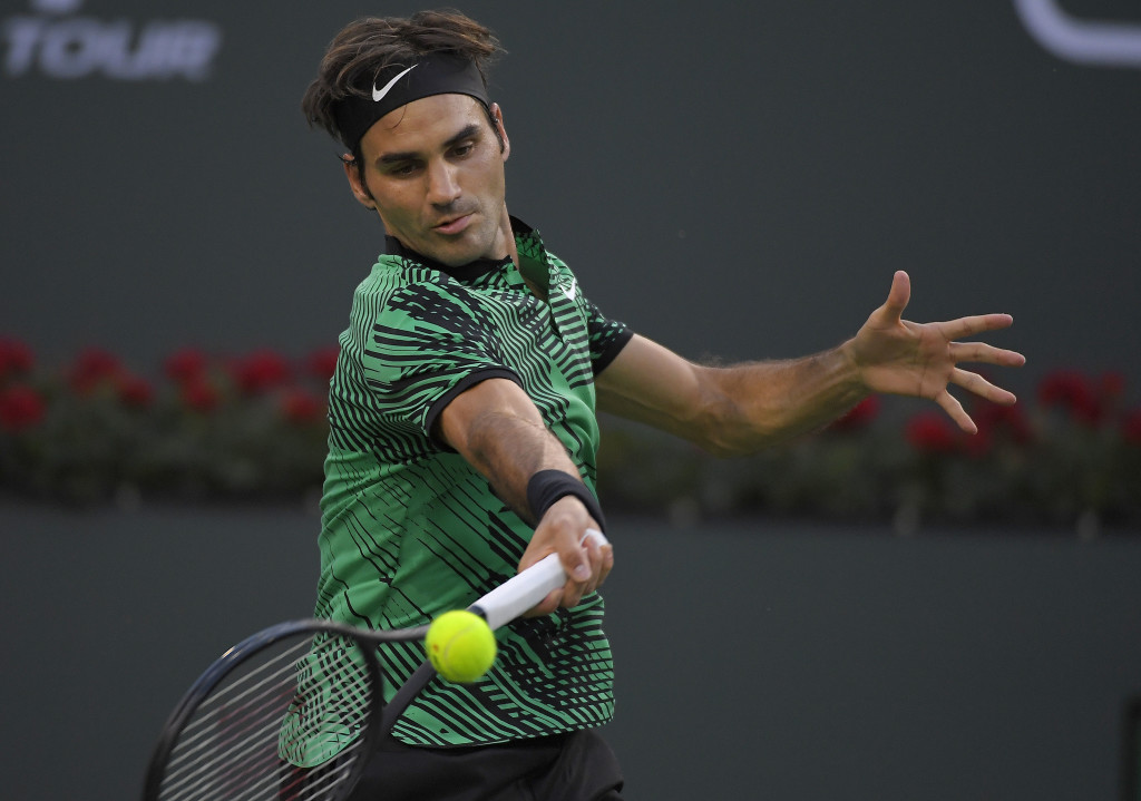Roger Federer, of Switzerland, returns a shot to Rafael Nadal, of Spain, at the BNP Paribas Open tennis tournament, Wednesday, March 15, 2017, in Indian Wells, Calif. (AP Photo/Mark J. Terrill)