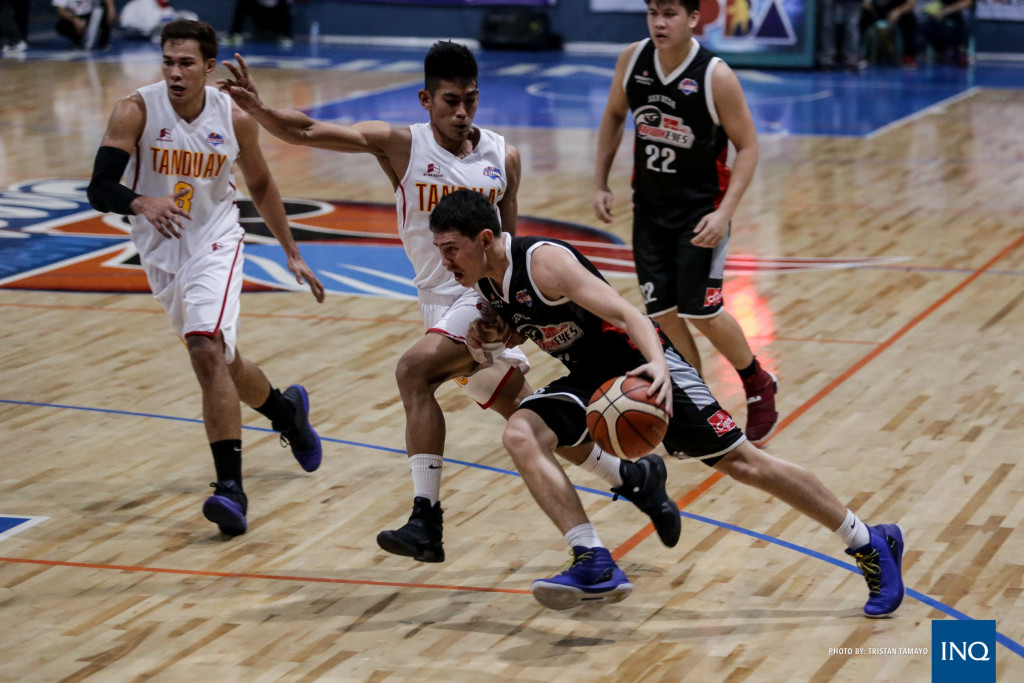 Robert Bolick tries to get away from the Tanduay defense. Photo by Tristan Tamayo/ INQUIRER.net