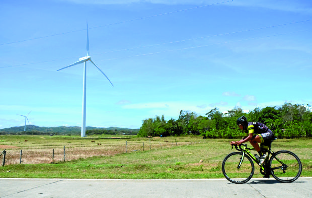 A cyclist passes a windmill in Barangay Cabano, San Lorenzo, in Guimaras province during Ronda Pilipinas’ stage 12 won byNavy’s Jan Paul Morales. —NIÑO JESUS ORBETA