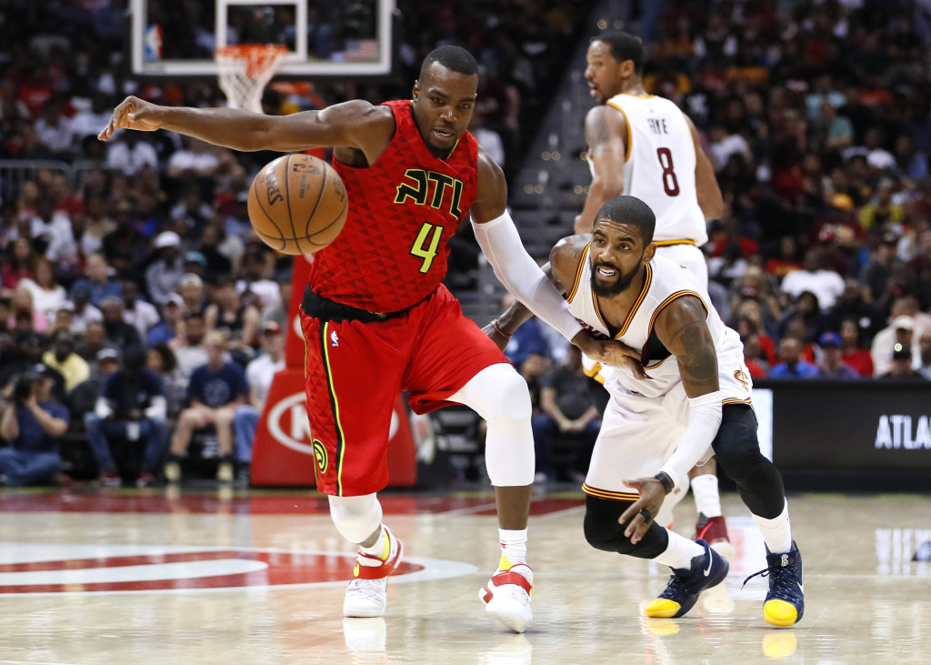 Atlanta Hawks forward Paul Millsap (4) and Cleveland Cavaliers guard Kyrie Irving (2) fight for the ball in the second half of an NBA basketball game on Sunday, April 9, 2017, in Atlanta. The Hawks won in overtime 126-125. (AP Photo/Todd Kirkland)