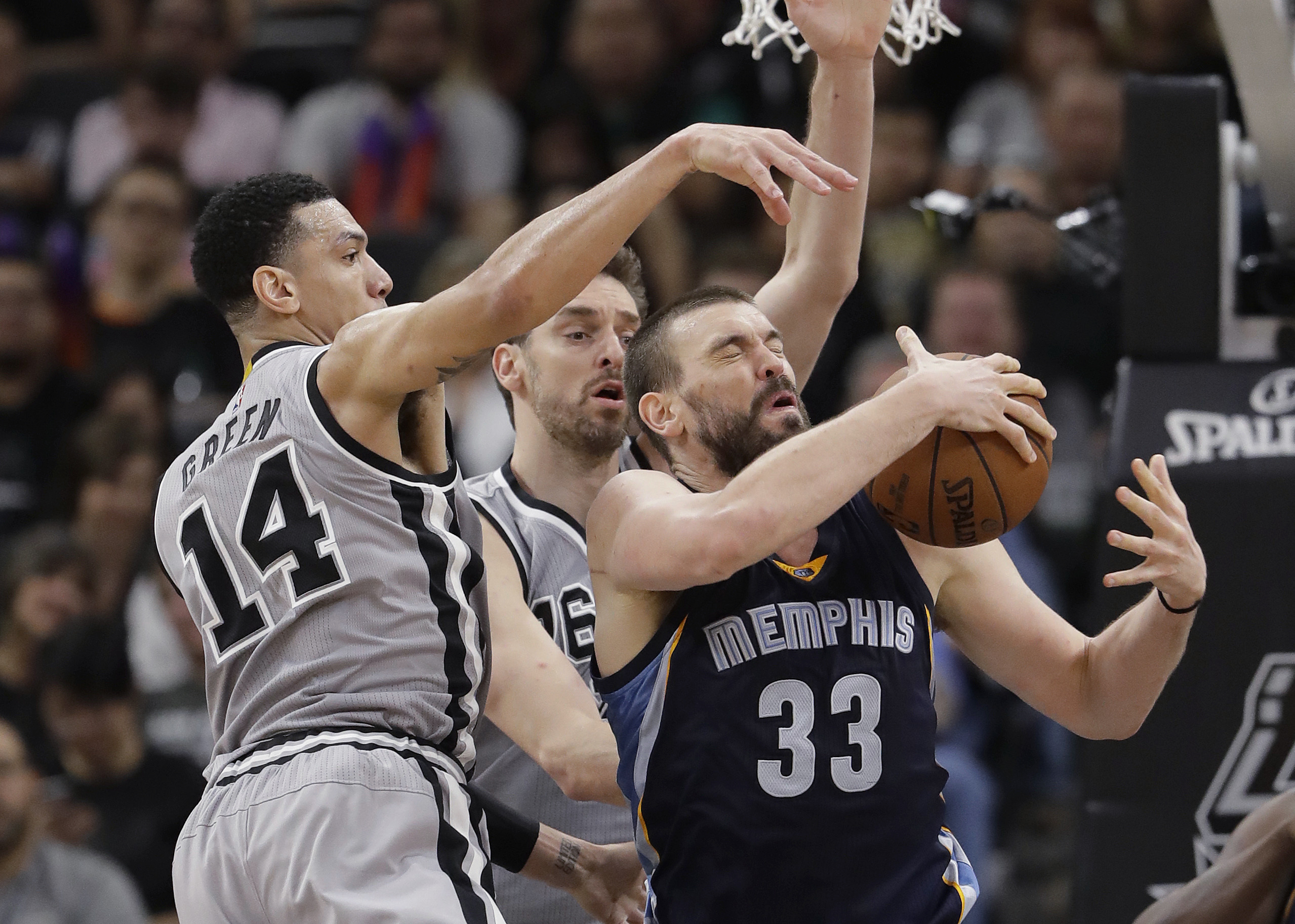 FILE - In this April 15, 2017, file photo, Memphis Grizzlies center Marc Gasol (33) is defended by San Antonio Spurs guard Danny Green (14) and center Pau Gasol during the second half in Game 1 of a first-round NBA basketball playoff series, in San Antonio. Pau and Marc Gasol have been battling each other on a basketball court since they were children with the older brother always finding ways to win. Now little brother Marc is doing his best to rally the Grizzlies to avoid being swept away in their first playoff meeting.  (AP Photo/Eric Gay, File)