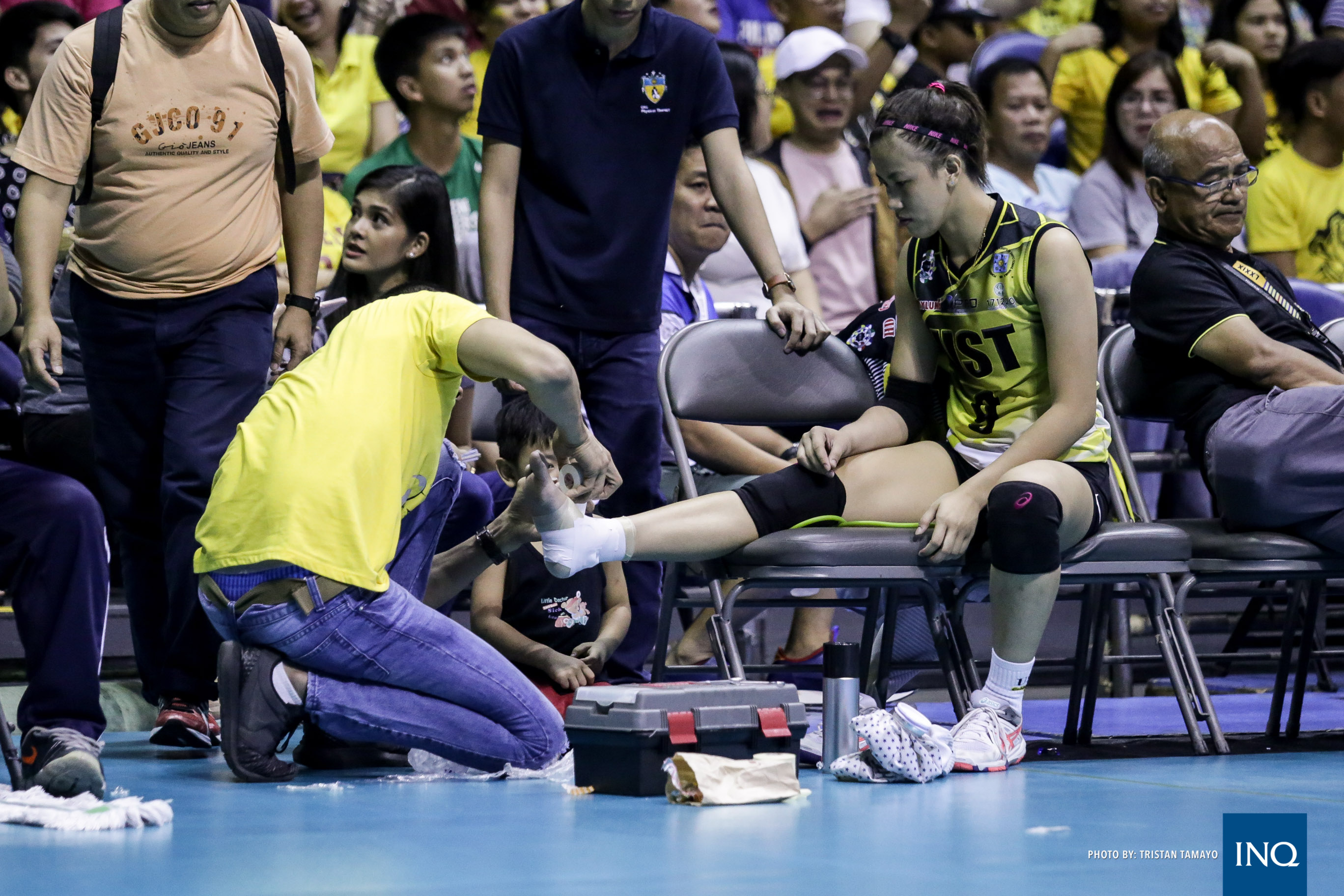 EJ Laure gets her injured ankle taped by father Eddie, a former PBA player. Photo by Tristan Tamayo/INQUIRER.net