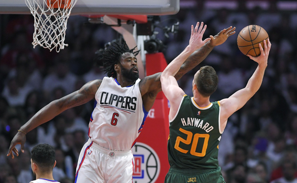Utah Jazz forward Gordon Hayward, right, shoots as Los Angeles Clippers center DeAndre Jordan defends during the second half in Game 5 of an NBA basketball first-round playoff series, Tuesday, April 25, 2017, in Los Angeles. The Jazz won 96-92. (AP Photo/Mark J. Terrill)