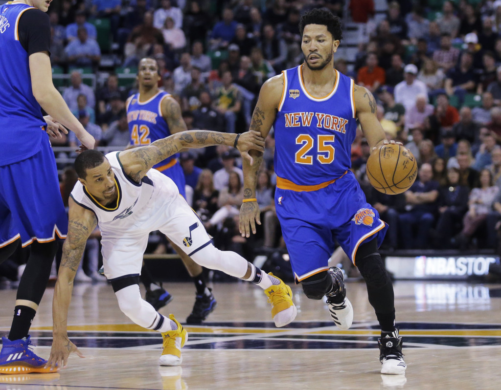 New York Knicks guard Derrick Rose (25) drives around Utah Jazz guard George Hill, left, during the first half during an NBA basketball game Wednesday, March 22, 2017, in Salt Lake City. (AP Photo/Rick Bowmer)