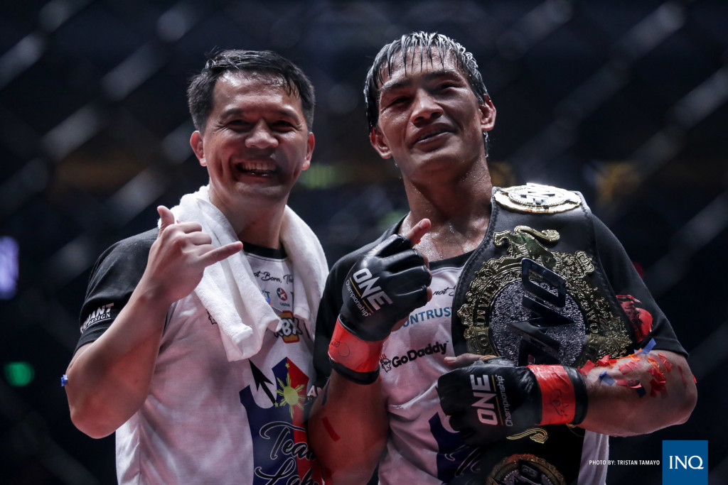 Team Lakay coach Mark Sangiao poses with ONE Lightweight Champion Eduard Folayang after his unanimous decision victory over Ev Ting at ONE: Kings of Destiny. Photo by Tristan Tamayo/ INQUIRER.net