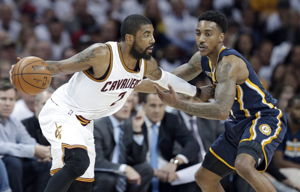 Cleveland Cavaliers' Kyrie Irving, left, drives past Indiana Pacers' Jeff Teague in the second half in Game 2 of a first-round NBA basketball playoff series, Monday, April 17, 2017, in Cleveland. The Cavaliers won 117-111. (AP Photo/Tony Dejak)