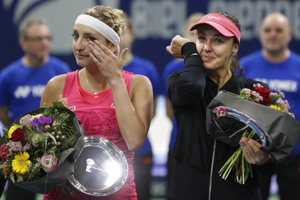 Martina Hingis, right, and Timea Bacsinszky of Switzerland cry during the flower ceremony of Taiwan, at the WTA Ladies Open tennis tournament in Biel, Switzerland, Sunday, April 16, 2017. (Peter Klaunzer/Keystone via AP)