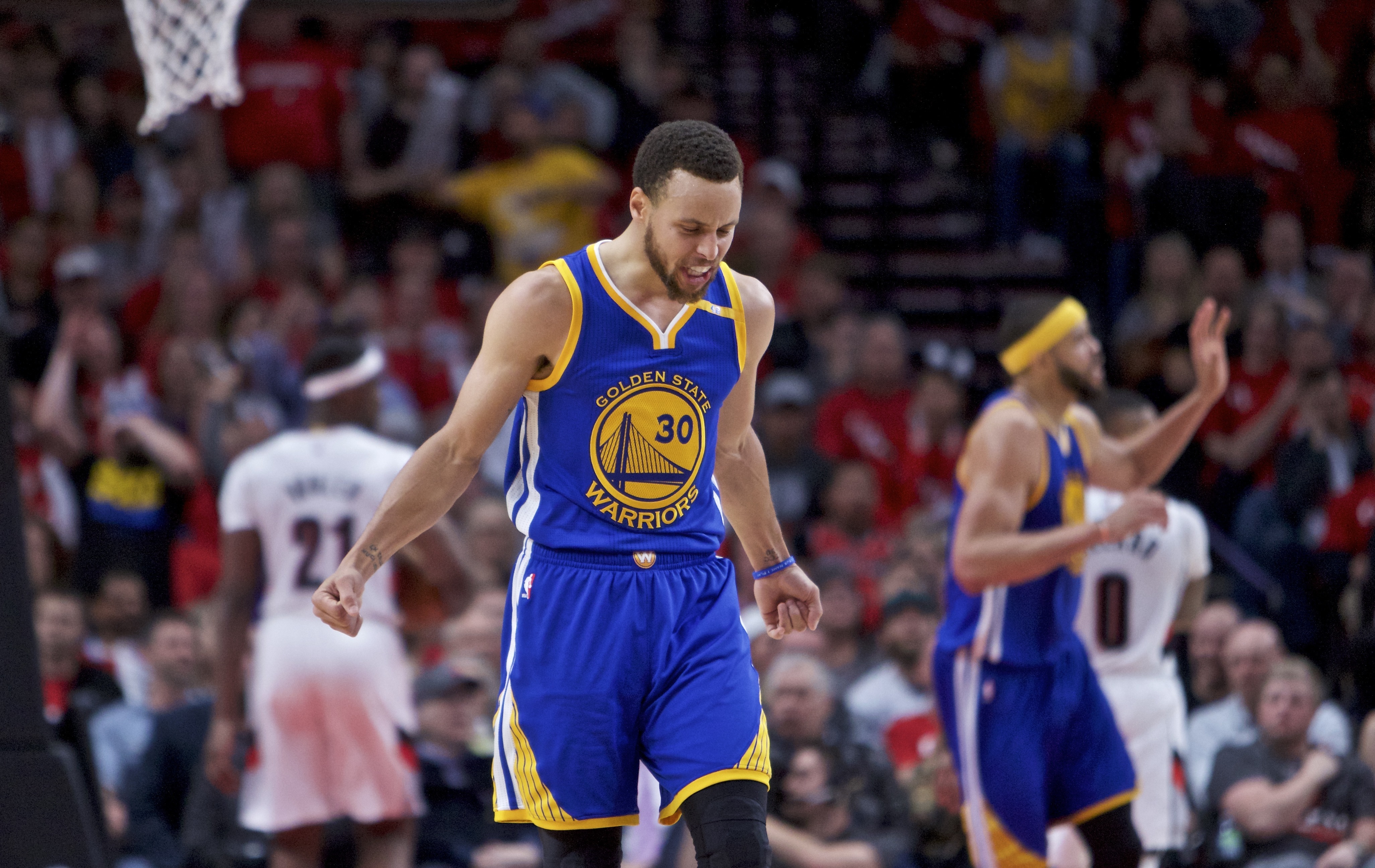 Golden State Warriors guard Stephen Curry reacts after making a basket against the Portland Trail Blazers during the second half of Game 3 of an NBA basketball first-round playoff series Saturday, April 22, 2017, in Portland, Ore. (AP Photo/Craig Mitchelldyer)