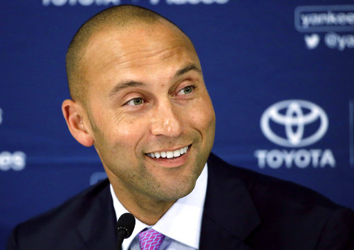 In this file photo, New York Yankees' Derek Jeter speaks to the media after the last baseball game of his career, against the Boston Red Sox, at Fenway Park in Boston. A person familiar with the situation tells The Associated Press that the former Yankees star Derek Jeter and former Florida Gov. Jeb Bush have joined forces in their attempt to buy the Miami Marlins. AP