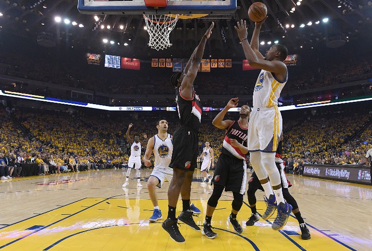 Kevin Durant #35 of the Golden State Warriors goes up for a layup over Noah Vonleh #21 of the Portland Trail Blazers in the first quarter during Game One of the first round of the 2017 NBA Playoffs at ORACLE Arena on April 16, 2017 in Oakland, California. AFP 