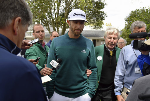 Dustin Johnson talks with media after deciding not to play in the opening round of the Masters golf tournament at the Augusta National Golf Club. AP