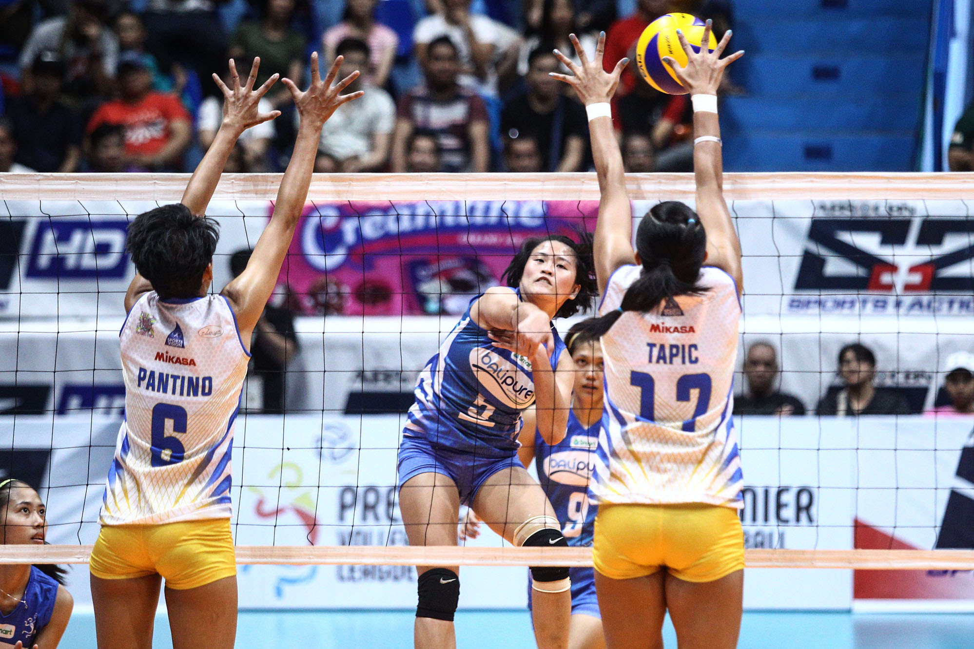 Grethcel Soltones of Bali Pure attempts a spike against two Philippine Air Force blockers. CONTRIBUTED PHOTO