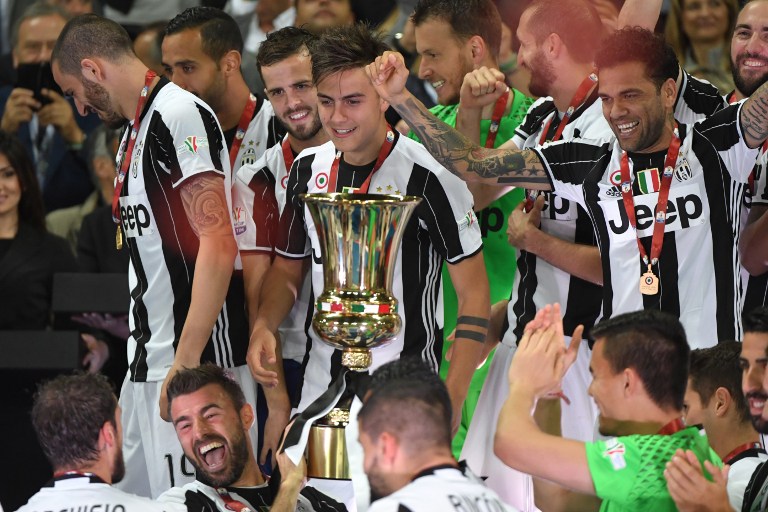 Juventus' players celebrate with the trophy after winning the Italian Tim Cup final on May 17, 2017 at the Olympic stadium in Rome.  / AFP PHOTO / Andreas SOLARO