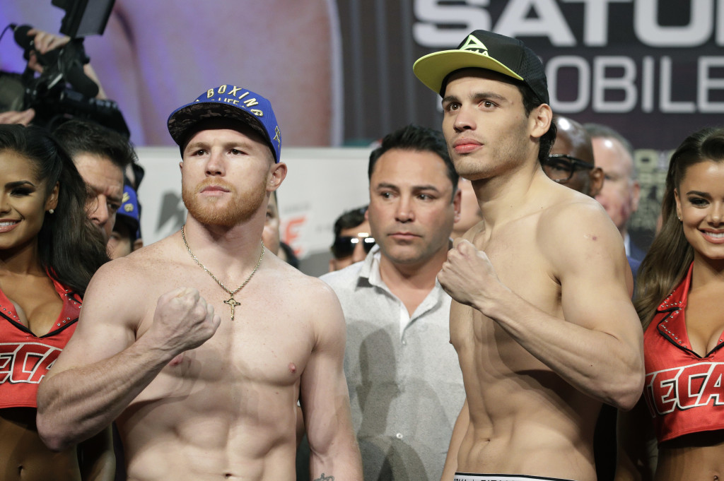 Canelo Alvarez, left, and Julio Cesar Chavez Jr. pose for photographers during a weigh-in Friday, May 5, 2017, in Las Vegas. The two are scheduled to fight Saturday in Las Vegas. (AP Photo/John Locher)