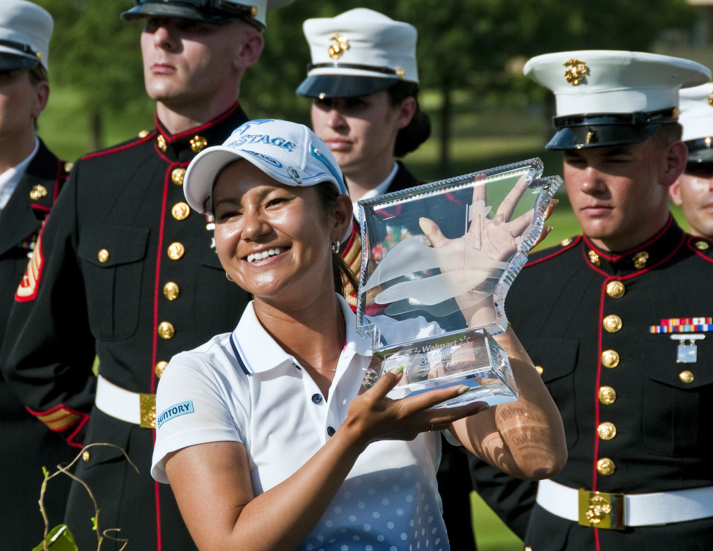 In this Sunday, July 1, 2012, file photo, Ai Miyazato poses with the championship trophy as members of the U.S. Marine Corps stand at attention behind her during a ceremony after Miyazato won the LPGA NW Arkansas Championship golf tournament in Rogers, Ark. Kyodo News reported Miyazato, a nine-time winner on the U.S. LPGA Tour, will retire at the end of this season, her management said Friday, May 26, 2017. (AP Photo/April L. Brown, File)