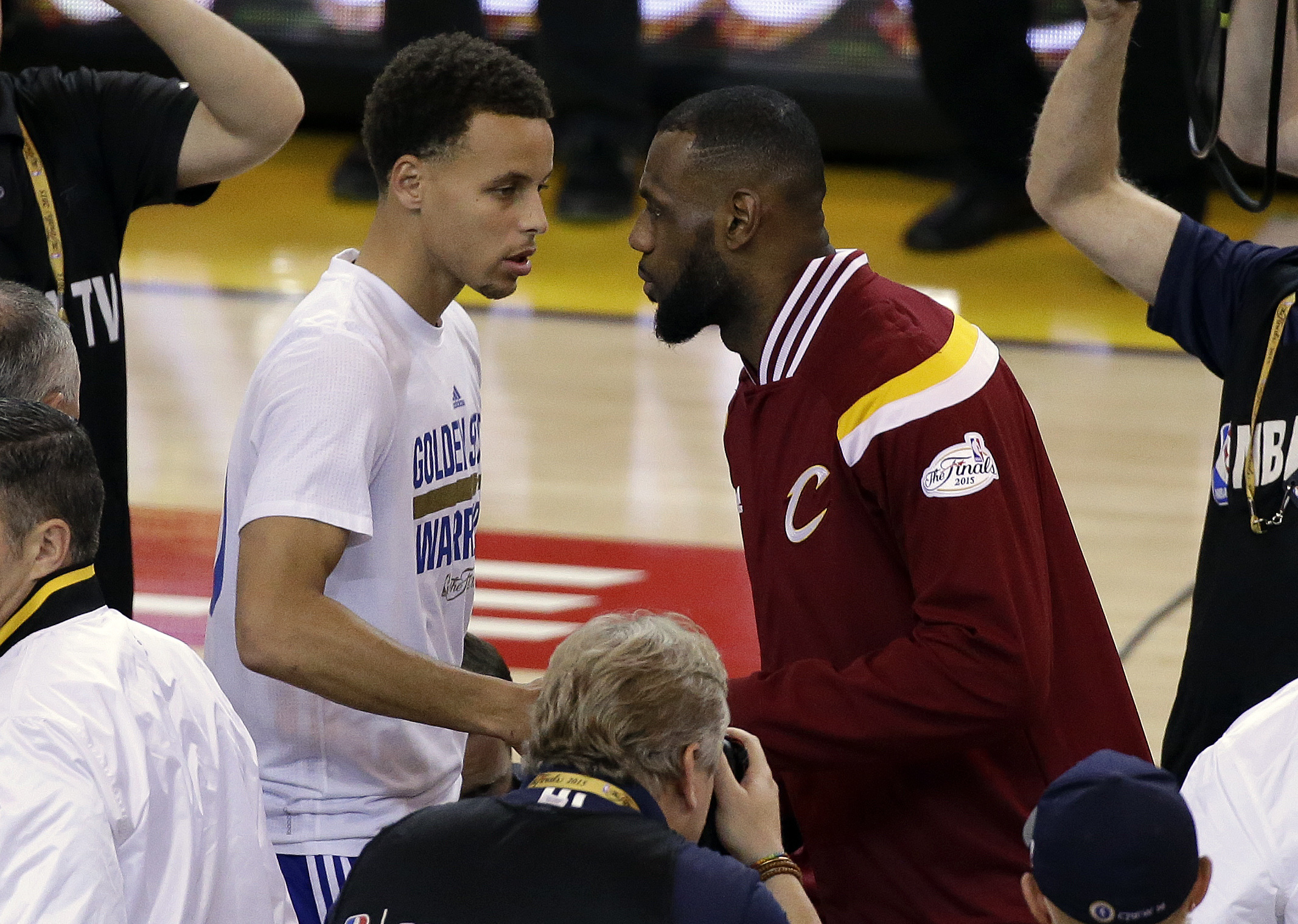 FILE - In this June 14, 2015, file photo, Golden State Warriors guard Stephen Curry, left, shakes hands with Cleveland Cavaliers forward LeBron James before Game 5 of basketball's NBA Finals in Oakland, Calif. While there have been 14 rematches in NBA Finals history, this year's meeting between LeBron James' Cleveland Cavaliers and Stephen Curry's Golden State Warriors will be the first trilogy in league history. (AP Photo/Eric Risberg)