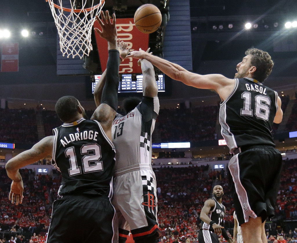 San Antonio Spurs center Pau Gasol (16) blocks the shot of Houston Rockets guard James Harden (13) as forward LaMarcus Aldridge defends during the second half in Game 6 of an NBA basketball second-round playoff series, Thursday, May 11, 2017, in Houston. San Antonio won 114-75. (AP Photo/Eric Christian Smith)