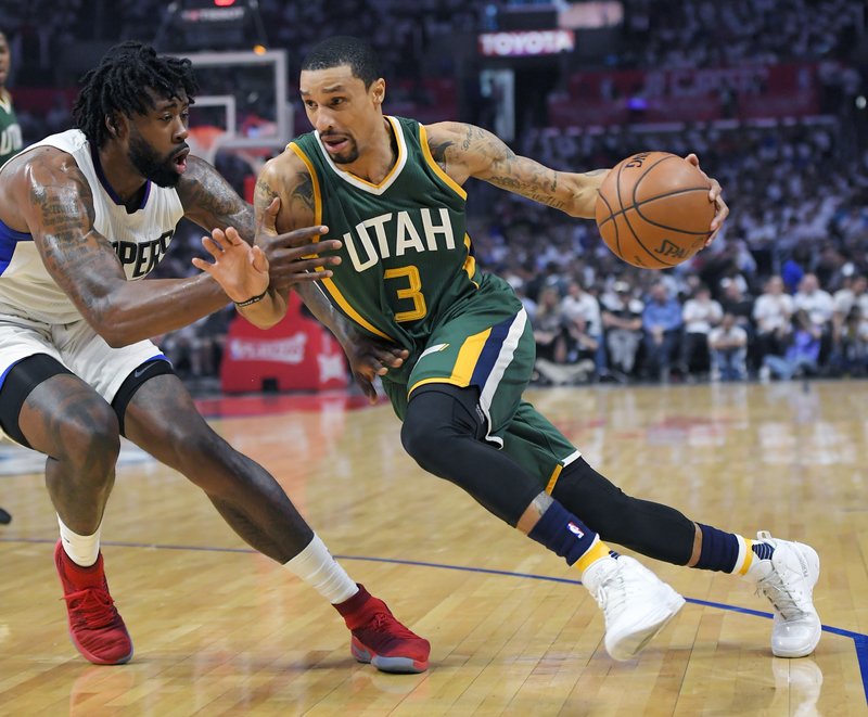 Utah Jazz guard George Hill, right, drives past Los Angeles Clippers center DeAndre Jordan during the first half in Game 7 of an NBA basketball first-round playoff series, Sunday, April 30, 2017, in Los Angeles. (AP Photo/Mark J. Terrill)