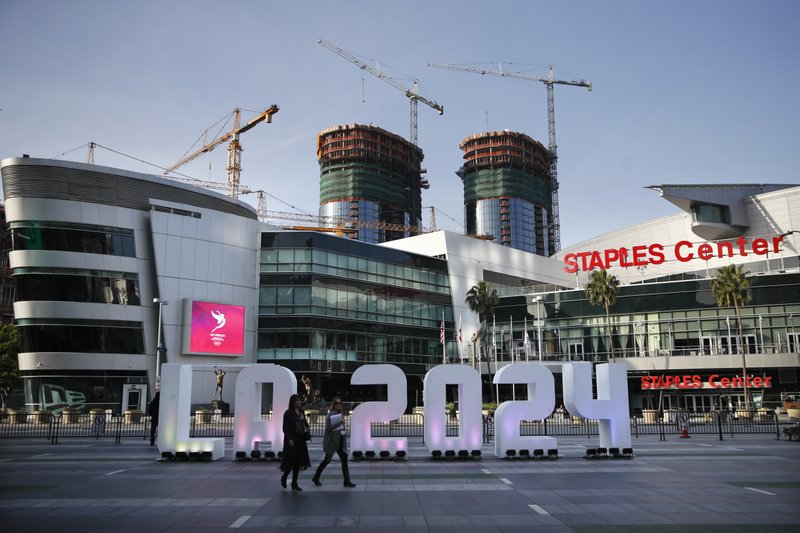 A Los Angeles 2024 sign stands in front of Staples Center Thursday, May 11, 2017, in Los Angeles. After bidding for the 2024 Olympics, Los Angeles might have to wait. With the competition down to LA and Paris, International Olympic Committee leaders are considering a proposal to award the next two Olympics, 2024 and 2028, one to each city. (AP Photo/Jae C. Hong)