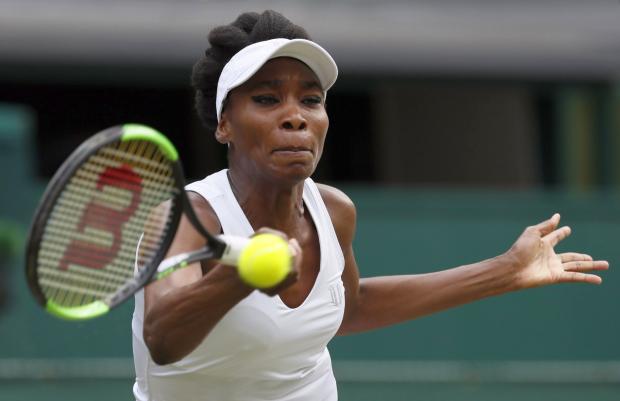 Venus Williams of the United States returns to Croatia’s Ana Konjuh during their Women’s Singles Match on day seven at the Wimbledon Tennis Championships in London Monday, July 10, 2017. (Photo by KIRSTY WIGGLESWORTH / AP)