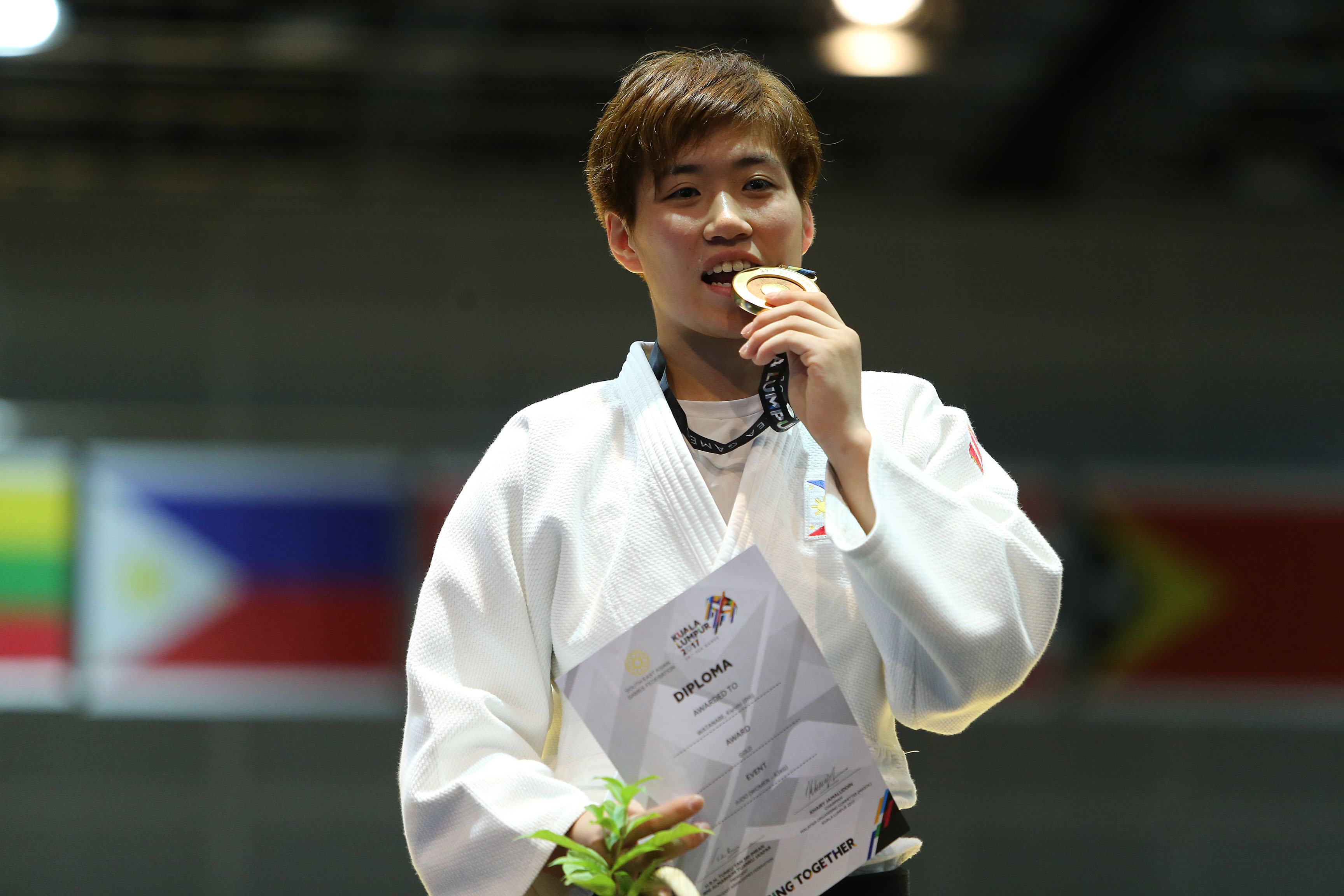 Kiyomi Watanabe of the Philippines clinches the gold medal in the women's -63kg event of the 29th Southeast Asian Games judo competition Saturday at the Kuala Lumpur Convention Center. 