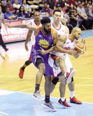 Sol Mercado of Ginebra (right) boxes out Moala Tautuaa of TNT for the rebound during Game 4 of their Final Four series on Sunday night at Smart Araneta Coliseum.  —AUGUST DELA CRUZ