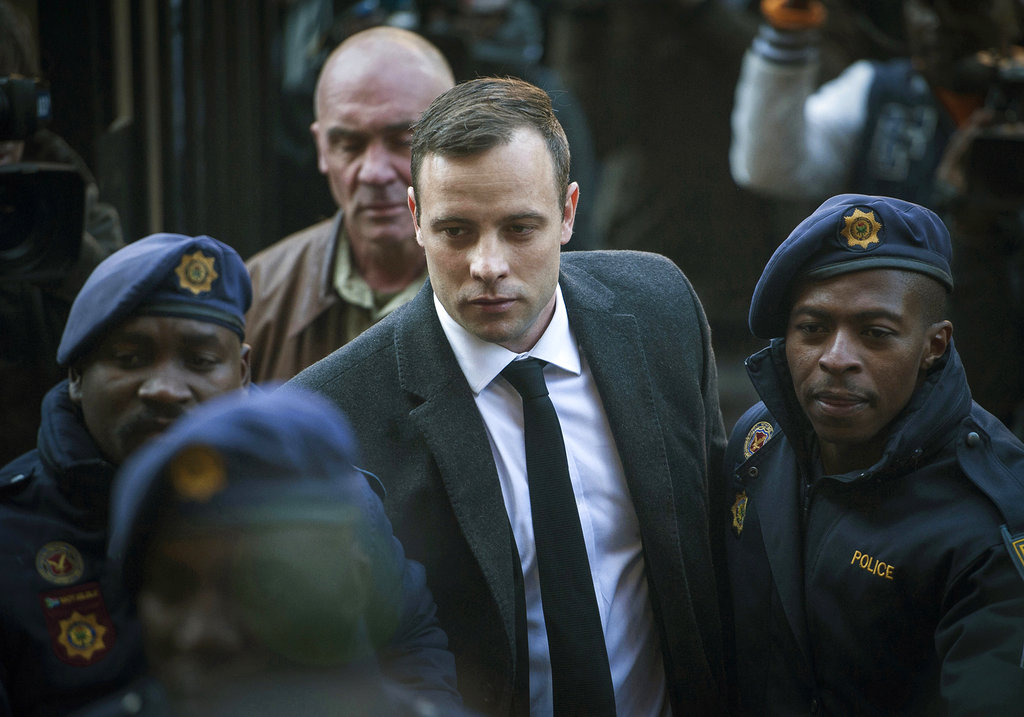 FILE - In this July 6, 2016, file photo, Oscar Pistorius, center, arrives at the High Court in Pretoria, South Africa, for a sentencing hearing for the murder of his girlfriend Reeva Steenkamp in his home 