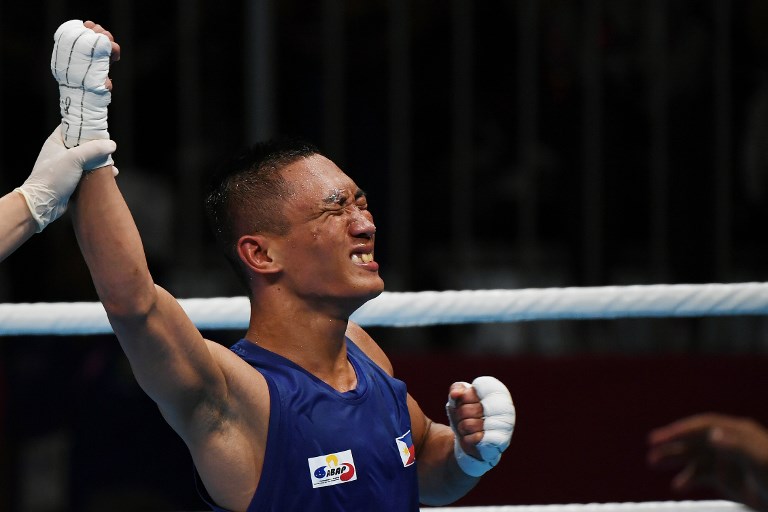 Philippines Rogen Ladon (blue) celebrates his win over Thailand's Yuttapong Tongdee (not pictured) following their men's fly (52kg) semi-finals boxing match at the 2018 Asian Games in Jakarta on August 31, 2018.