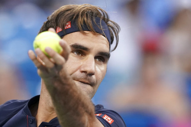Roger Federer, of Switzerland, prepares to serve to David Goffin, of Belgium, during the semifinals at the Western & Southern Open tennis tournament Saturday, Aug. 18, 2018, in Mason, Ohio. (AP Photo/John Minchillo)