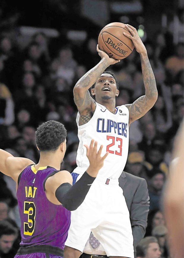 Clippers guard Lou Williams puts a shot up against the Lakers’ Josh Hart. AP
