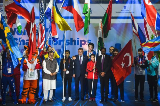 mov (C) poses with flag bearers of participating countries during the inauguration ceremony of the 2018 International Boxing Association (AIBA) Women's World Boxing Championships in New Delhi on November 14, 2018. 