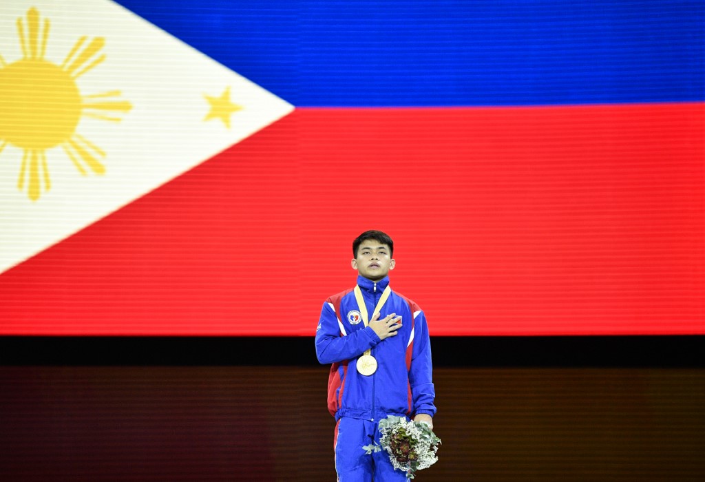 Philippines' Carlos Edriel Yulo poses with gold medal on the podium during the medal ceremony for the Men's Floor event after the apparatus finals at the FIG Artistic Gymnastics World Championships at the Hanns-Martin-Schleyer-Halle in Stuttgart, southern Germany, on October 12, 2019. 