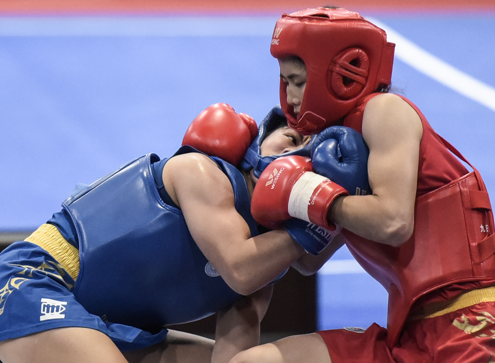 DECEMBER 3, 2019: Philippines' Wally Divine (blue) grapples with Vietnam's Nguyen Thi Chinh (red) during the women's Sanda 48 kg category in the Wushu competition final in the 30th South East Asian Games 2019. INQUIRER PHOTO/ Sherwin Vardeleon