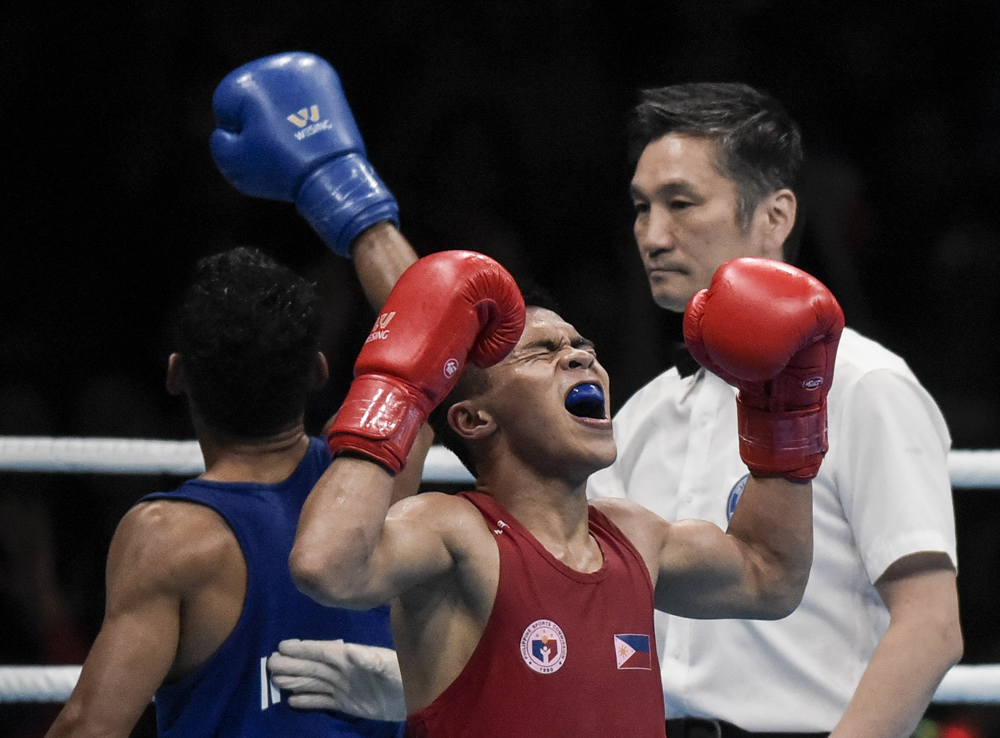 Philippines' Carlo Paalam celebrates after defeating Indonesia's Langu Kornelis Kangu to claim the gold medal during the 30th South East Asian Games 2019 Men's Light Flyweight Final (46-49 kg).