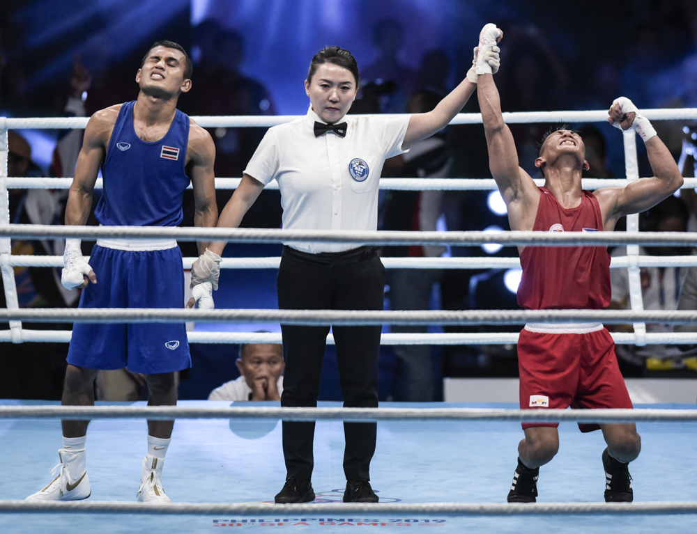 DECEMBER 9, 2019: Philippines' Rogen Ladon celebrates after defeating Thailand's Yaodam Ammarit to claim the gold medal during the 30th South East Asian Games 2019 Men's Flyweight (52 kg)