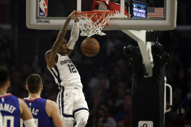 Memphis Grizzlies' Ja Morant (12) dunks against the Los Angeles Clippers during the first half of an NBA basketball game Saturday, Jan. 4, 2020, in Los Angeles. (AP Photo/Marcio Jose Sanchez)