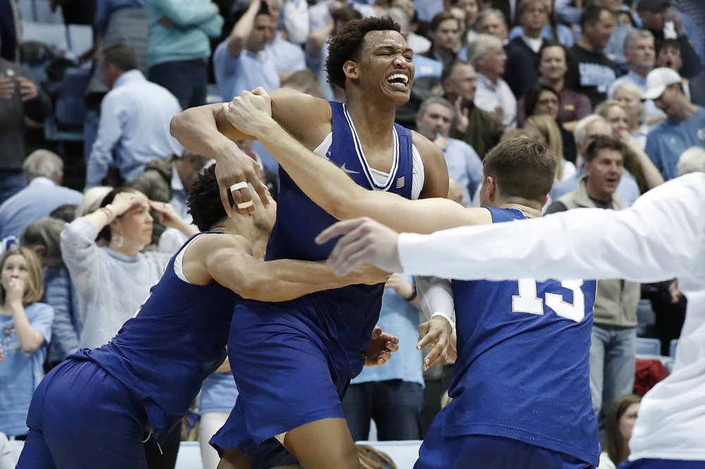 Duke UNCDuke forward Wendell Moore Jr., center, celebrates with guard Jordan Goldwire and forward Joey Baker (13) following Moore's game-winning shot in overtime of an NCAA college basketball game against North Carolina in Chapel Hill, N.C., Saturday, Feb. 8, 2020. (AP Photo/Gerry Broome)