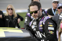 FILE - In this Feb. 16, 2020 file photo Jimmie Johnson climbs intp his car before the NASCAR Daytona 500 auto race at Daytona International Speedway in Daytona Beach, Fla. NASCAR seven-time champion Jimmie Johnson will test an Indy car next week on the road course at Indianapolis Motor Speedway. He’s long said he is open to racing in the series but did not want to compete on ovals out of safety concerns. On Friday, July 3, 2020, he indicated recent safety improvements have softened his stance and the Indianapolis 500 is not entirely out of the picture.AP Photo/John Raoux, File