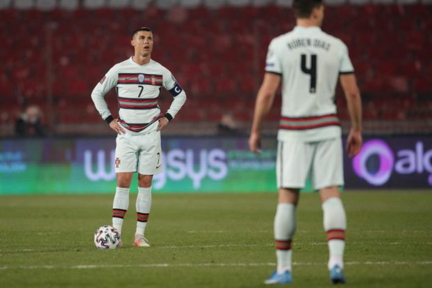 Portugal's forward Cristiano Ronaldo (L) reacts during the FIFA World Cup Qatar 2022 qualification Group A football match between Serbia and Portugal at the Rajko Mitic Stadium, in Belgrade, on March 27, 2021. (Photo by pedja milosavljevic / AFP)