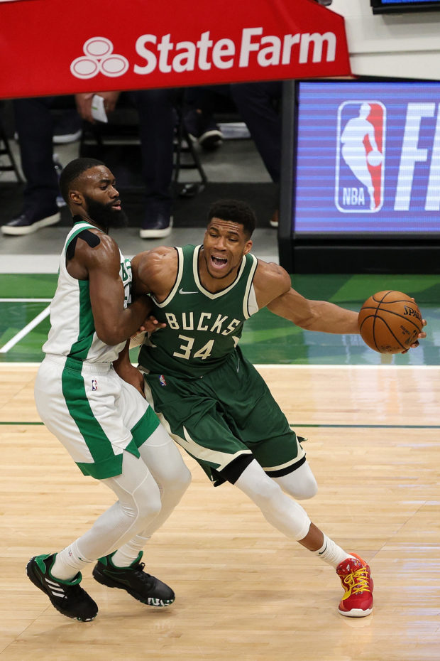 Giannis Antetokounmpo #34 of the Milwaukee Bucks is defended by Jaylen Brown #7 of the Boston Celtics during the second half of a game at Fiserv Forum on March 24, 2021 in Milwaukee, Wisconsin. NOTE TO USER: User expressly acknowledges and agrees that, by downloading and or using this photograph, User is consenting to the terms and conditions of the Getty Images License Agreement. Stacy Revere/Getty Images/AFP (Photo by Stacy Revere / GETTY IMAGES NORTH AMERICA / Getty Images via AFP)