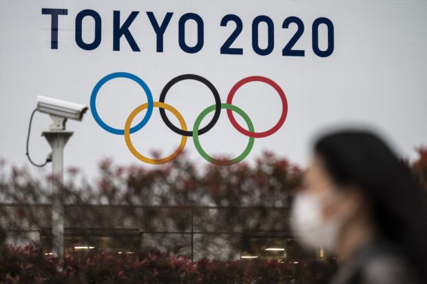 A Tokyo 2020 Olympics Games banner is displayed on the wall of the Tokyo Metropolitan Government building in Tokyo on April 13, 2021. (Photo by Charly TRIBALLEAU / AFP)