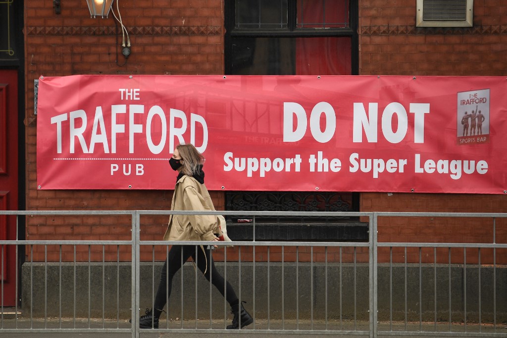A banner against the proposed European Super League hangs from a pub close to Manchester United's Old Trafford stadium in Manchester