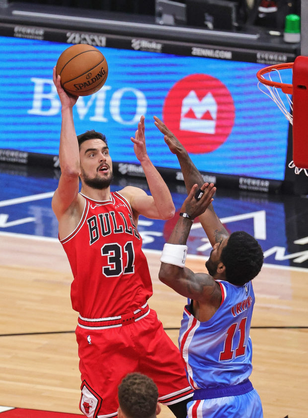 Tomas Satoransky #31 of the Chicago Bulls shoots over Kyrie Irving #11 of the Brooklyn Nets at the United Center on April 04, 2021 in Chicago, Illinois. 